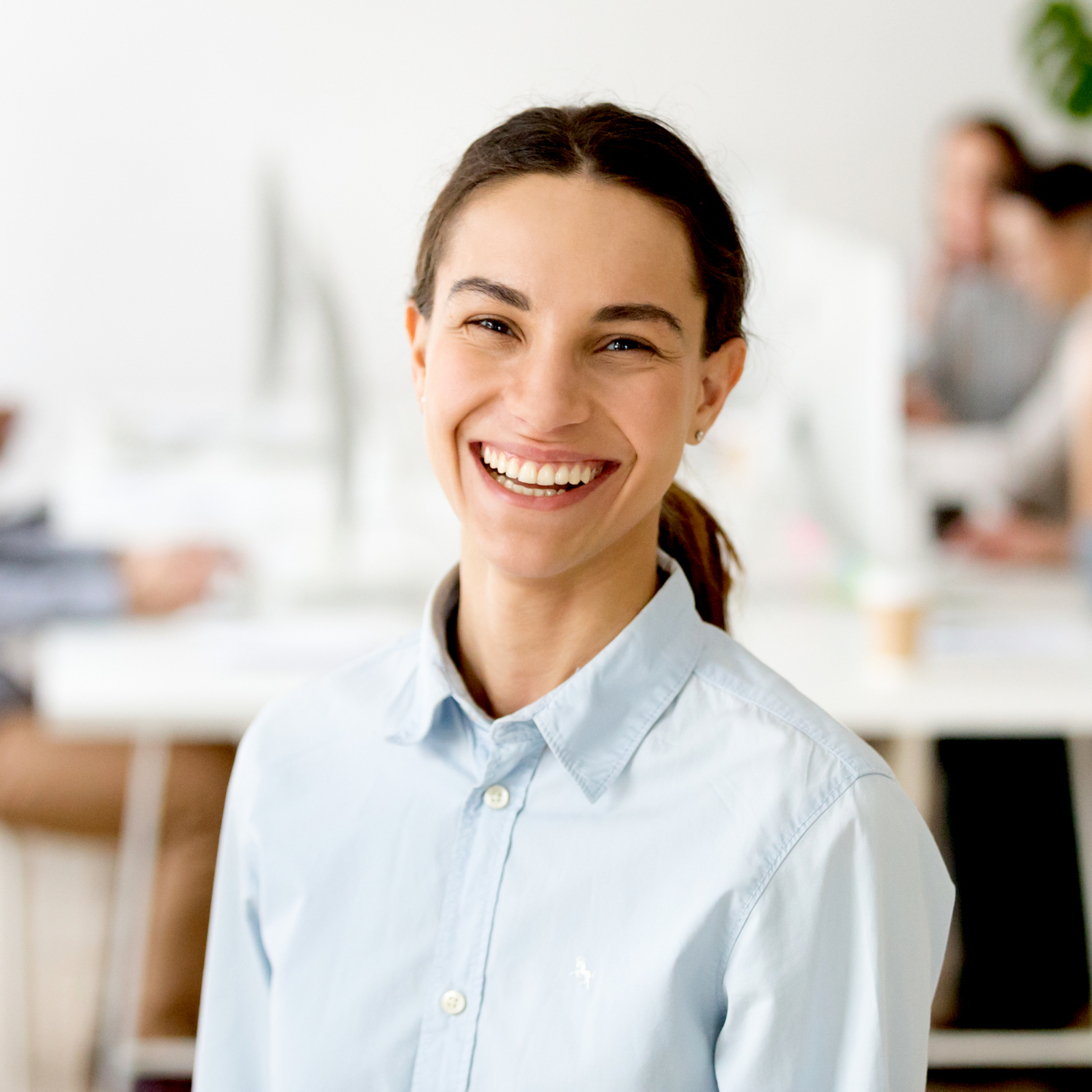 Cheerful happy millennial girl intern laughing looking at camera